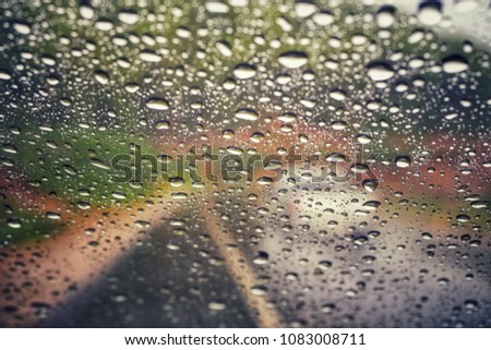 Rain drops on car glass background.