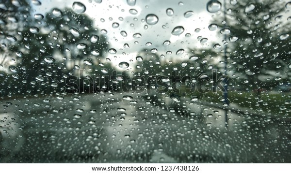 Rain drops on car glass. View rain drops on\
car window glass. Rain drops on car\
glass.
