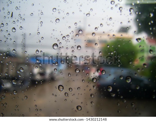 rain\
drops on car window / rain drops on a  car\
glasses.