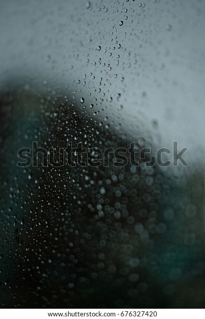 rain drops on\
a car window during a\
thunderstorm