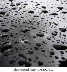 Rain drops on a car windscreen, low light evening contrast. Monochrome black and white, social comment image - Shutterstock ID 1758027017