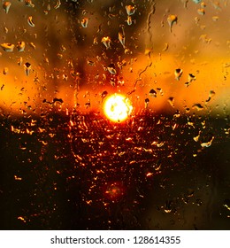 Rain Drops On The Glass Against The Setting Sun