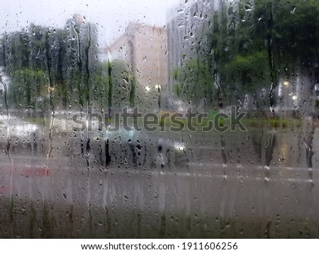 Similar – Rainy day I View through a wet window pane onto a busy street