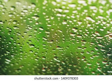 Rain Drops On Glass Widow Of A Car On A Rainy Day.