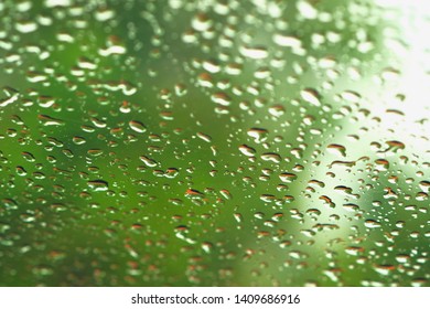 Rain Drops On Glass Widow Of A Car On A Rainy Day.