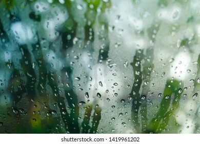 Rain Drops On Glass Widow Of A Car On A Rainy Day.