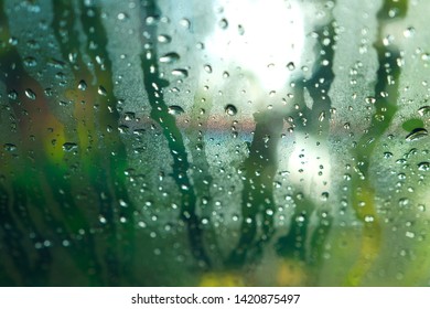 Rain Drops On Glass Widow Of A Car On A Rainy Day.