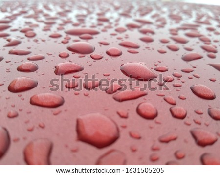 rain drops on the red car roof