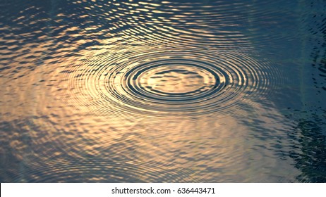 Rain Drops On The Swimming Pool Blue Water Surface That Have Ripple Wave Effect On Liquid Texture And Top View Angle.