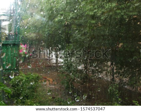 Similar – Rainy day I View through a wet window pane onto a busy street