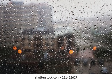 Rain drops on the window in the big city. Big building on the background. - Powered by Shutterstock