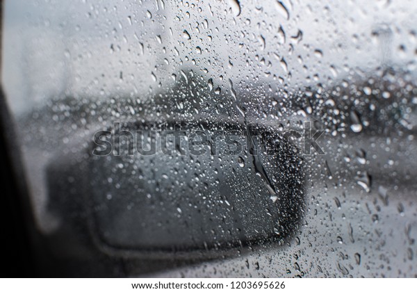 Rain drops on the window\
of the car