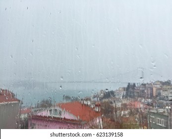 Rain Drops On Window Pane Against Buildings In Istanbul, Turkey