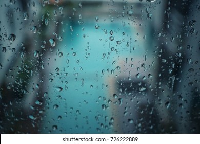 Rain Drops On The Window In Rainy Day. Background Concept.