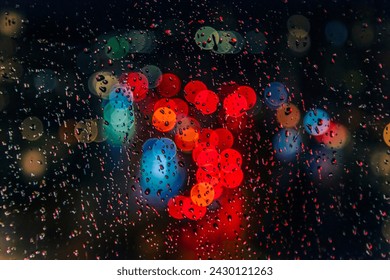 rain drops on the window surface with traffic bokeh light 
