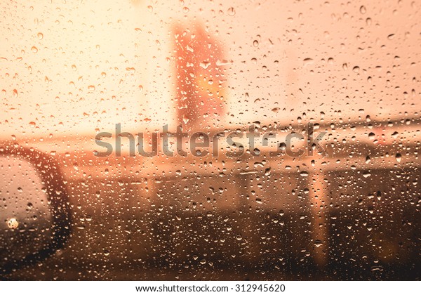 Rain drops on the window\'s car with traffic\
blur,Vintage tone