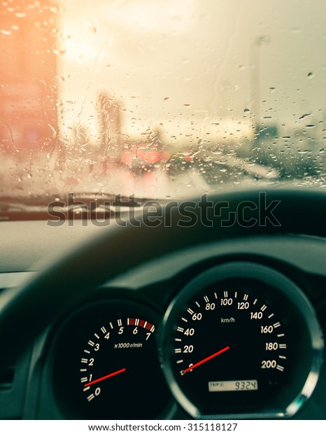 Rain drops on the window's car with traffic
blur,Vintage tone
