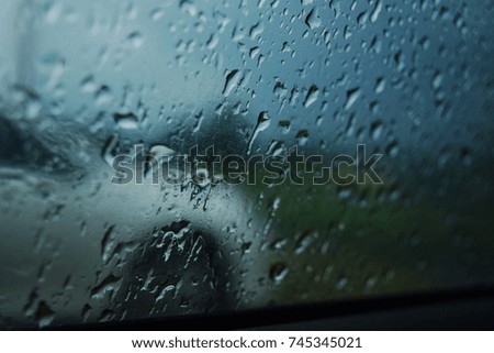 Rain drops outside the windshield.
