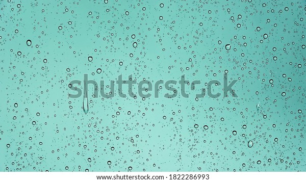 Rain\
drops running down a car window in a close up\
view