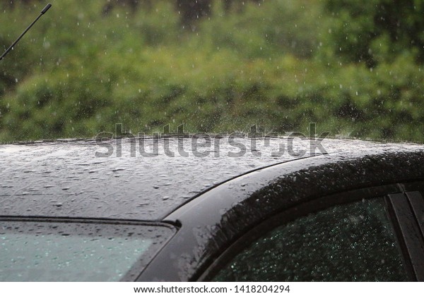 rain is falling on a roof\
from a car