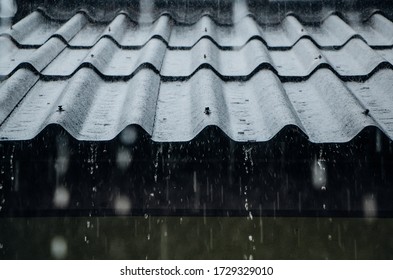 rain flows down from a roof down - Shutterstock ID 1729329010