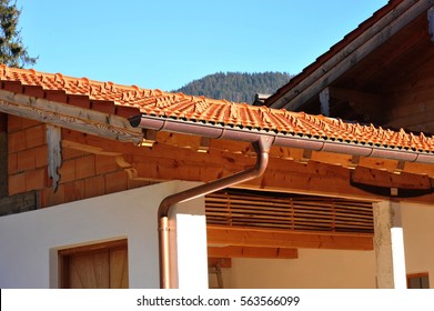 Rain Gutter, Rainwater Pipe Of Copper And Snow Guard On A Tiled Roof