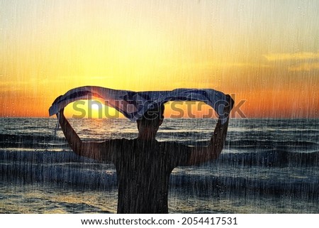 Rain in Israel, Israeli patriot with the Flag of Israel gets wet in the rain at sunset during a storm by the sea. Effect of Photographing through the Glass with Rain Drops Stock photo © 