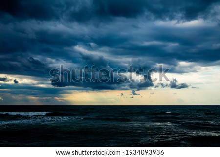 rain and large dark clouds over the sea