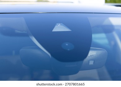 Rain and light sensor on the windshield of the car. Close up view of modern driver assistance. Car System Intelligence - Surround View 360 Degrees Bird Eye View, Line Assist, Front Camera.