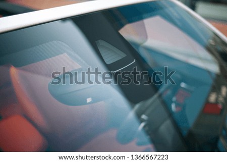 Rain and light sensor on the windshield of the convertible car. Clean glass of the modern car. Convertible car from windshield close up