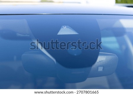 Rain and light sensor on the windshield of the car. Close up view of modern driver assistance. Car System Intelligence - Surround View 360 Degrees Bird Eye View, Line Assist, Front Camera.