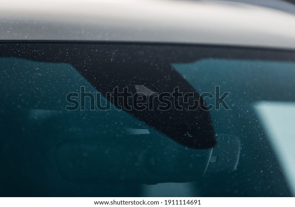 Rain and\
light sensor on the windshield of the\
car