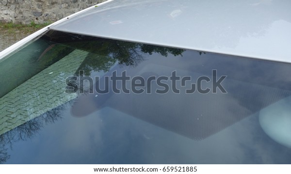 Rain and light sensors position, luxury car\
windscreen, blue tinted glass, front view, technology design. Blue\
isolated glass and dimming rear mirror with ips system, electric\
heated windshield