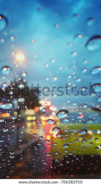 Rain on car window with\
street lights