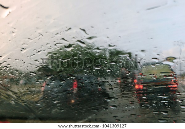 Rain on the car\
window. Window wet after rain. Condensate on glass on blurred\
background, defocused. Beautiful background, texture, abstract\
pattern. After rain\
concept.