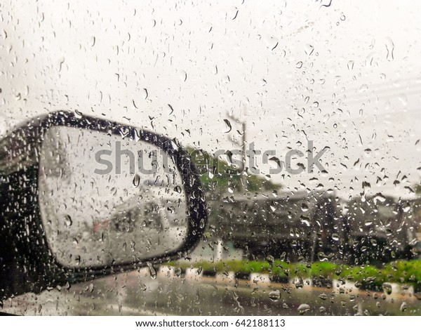 Rain on car windows\
and rearview mirrors.