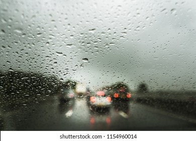 Rain on the motorway, heavy rain on the windshield, windscreen whilst driving on the motorway in a car, van, truck, dangerous driving conditions, bad weather, accident,