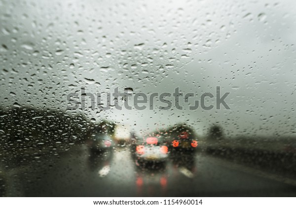 Rain on the motorway,
heavy rain on the windshield, windscreen whilst driving on the
motorway in a car, van, truck, dangerous driving conditions, bad
weather, accident,