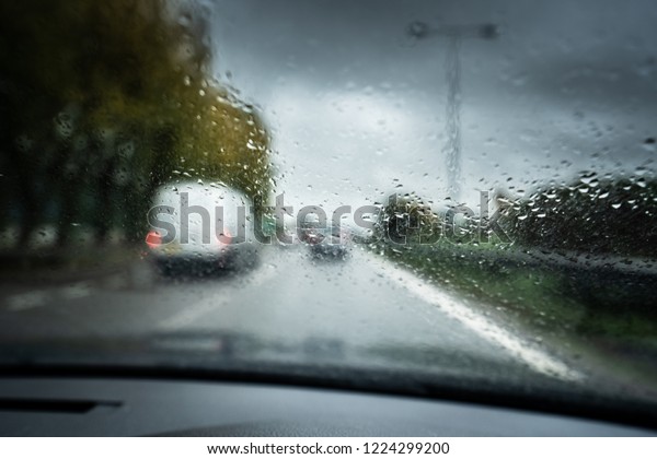Rain on the\
motorway, heavy rain on the windshield, windscreen whilst driving\
on the motorway in a car, van,\
truck