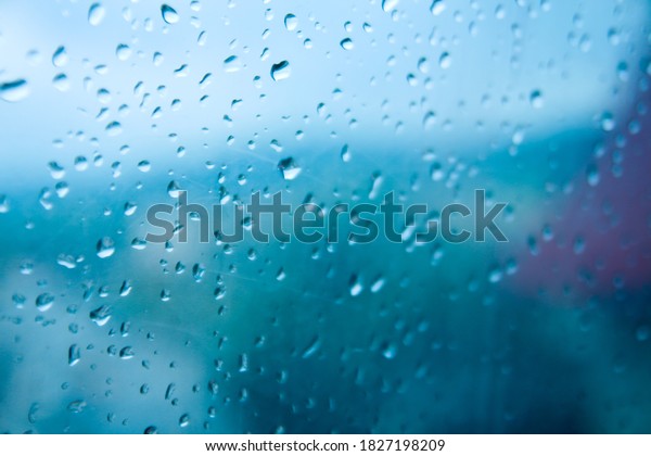 Rain on the\
window of the car - close up of water. Droplets of water on the\
window. Water on the window of\
car.