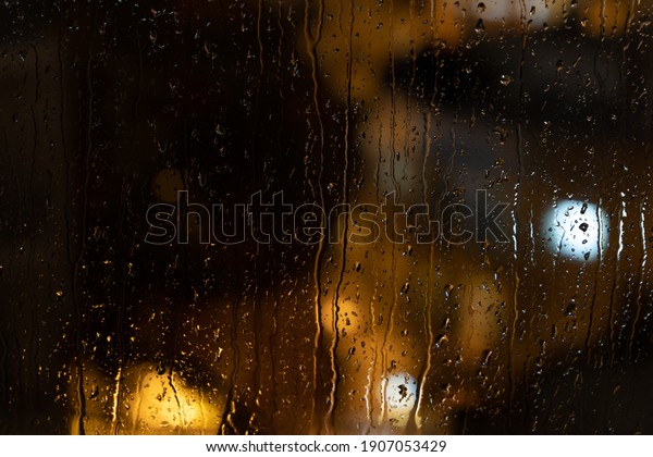 rain on window and\
lights of the torches