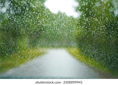 Rain on the windshield. Traveling in Sweden by car. Driving through the forest. Backdrop for stories about travelling, nature, climate, weather, rain and adventures in Scandinavia. Swedish summer - Powered by Shutterstock