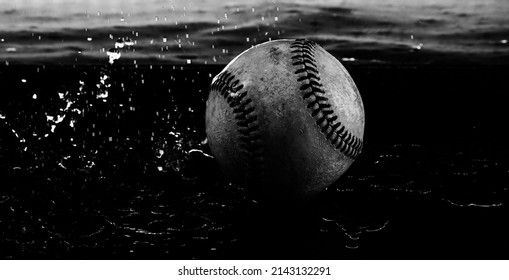 Rain Out Concept With Water Splash On Old Baseball Ball Close Up.