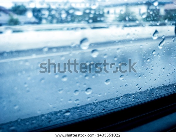 Rain\
outside the car glass  And blurred\
background