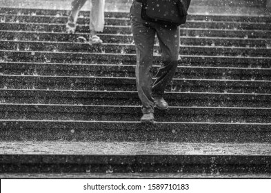 In the rain. People go down the stairs. Wet clothes and shoes. Screensaver for your desktop.  rain, sweat, water, gray, drops, large