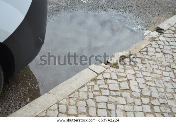 Rain puddle on the
road outdoor background