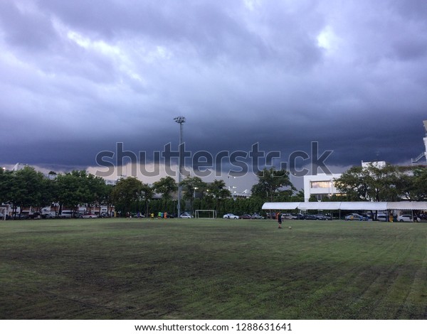 Rain storm clouds on\
football field