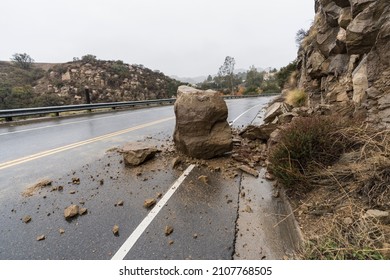 Rain storm rockslide blocking traffic lane on Santa Susana Pass Road in the Chatsworth area of Los Angeles, California.   - Shutterstock ID 2107768505