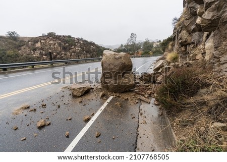 Rain storm rockslide blocking traffic lane on Santa Susana Pass Road in the Chatsworth area of Los Angeles, California.   [[stock_photo]] © 