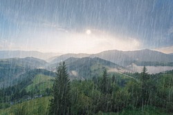 Rain And Sun Through The Clouds Over The Green Summer Carpathian Foggy Mountain Hills. Rainy Evening Panorama.